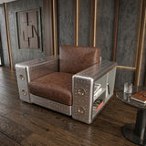 Aviator Industrial Aluminum Armchair with stacked books in armrest shelving